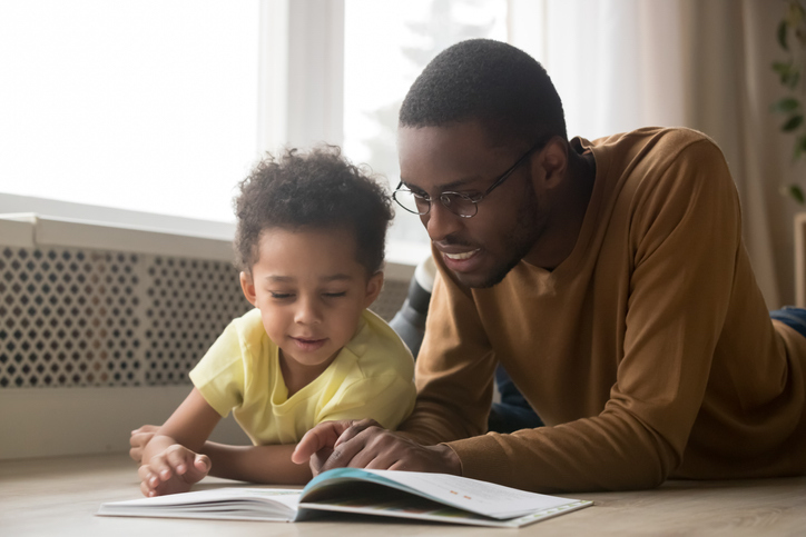 black father read to child