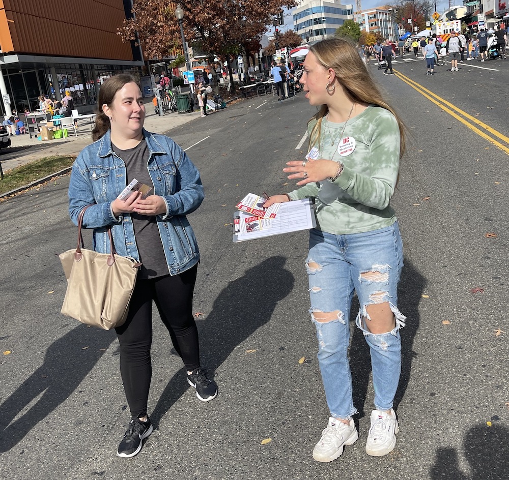 DC tutoring and mentoring initiative canvasser approaching passerby